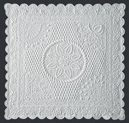 Dentelle blanche décorative carrée avec motifs floraux et géométriques, bord scallopé intricé et motif central en rosace.